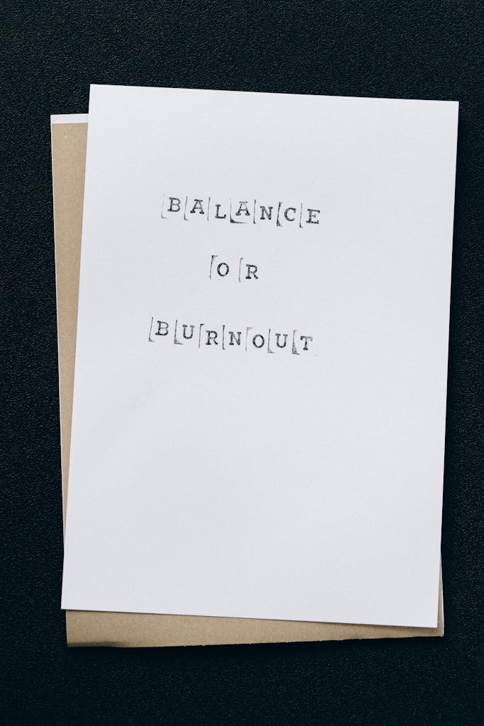 A simple card displaying the message 'Balance or Burnout' emphasizing mental health and stress management.